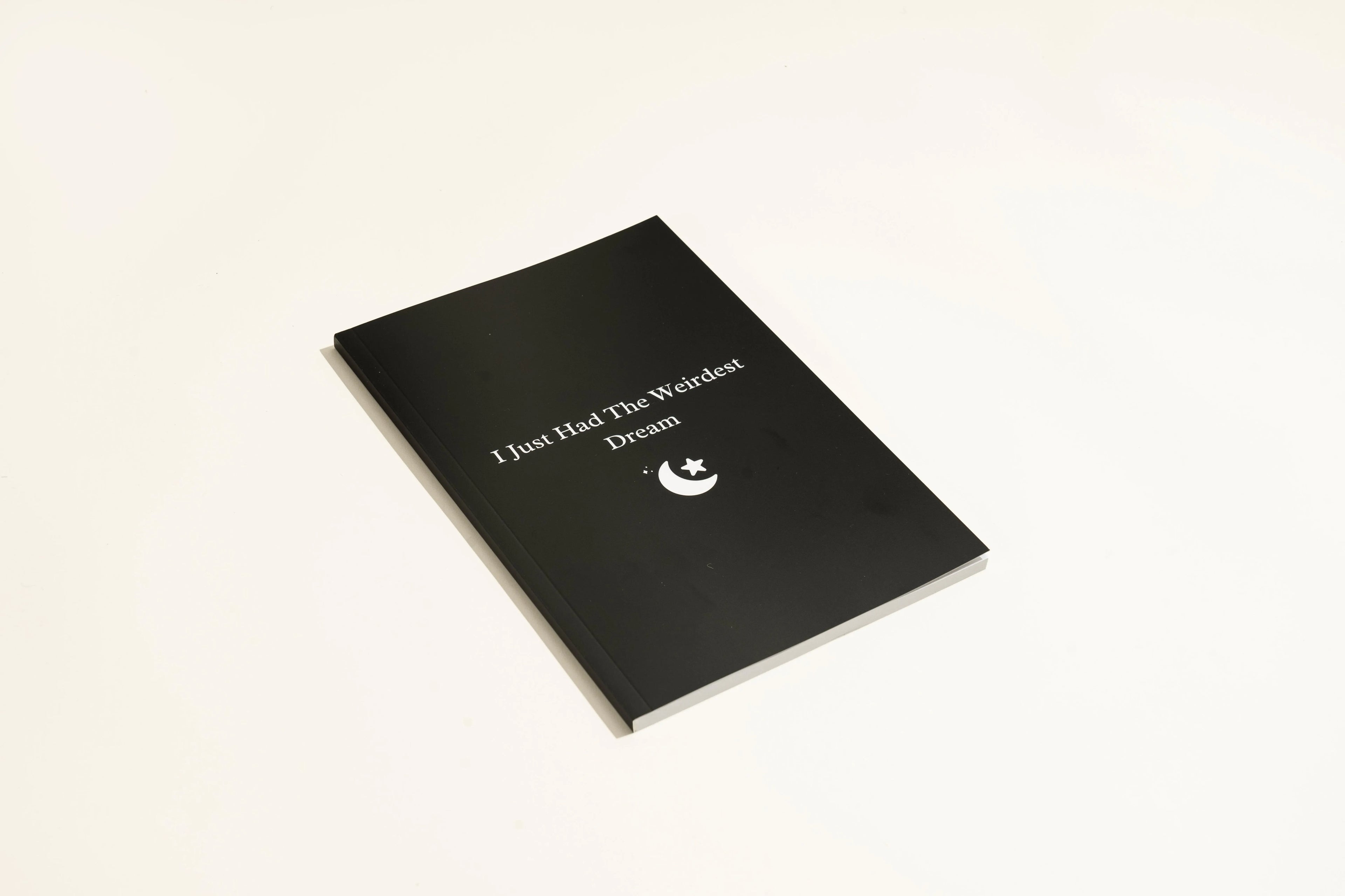 Black leather A5 dream journal notebook with embossed cover and lined pages