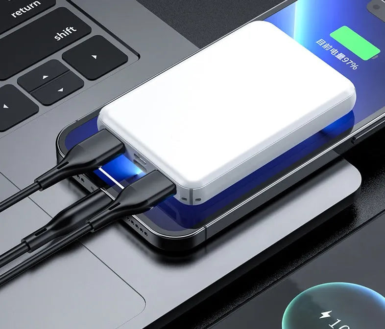 Black rectangular electric heating vest power bank with USB port, shown next to a measuring tape.