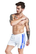 Men's blue polyester sports shorts with lace-up front and slim fit, shown on a hanger.
