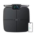 Black eight-electrode body fat scale on a bathroom floor showing digital display.