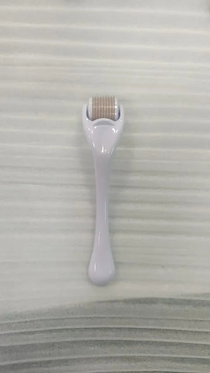 Professional 540 needle dermaroller for mechanical font with coloured handle and wheel, showing sterile stainless steel needles.