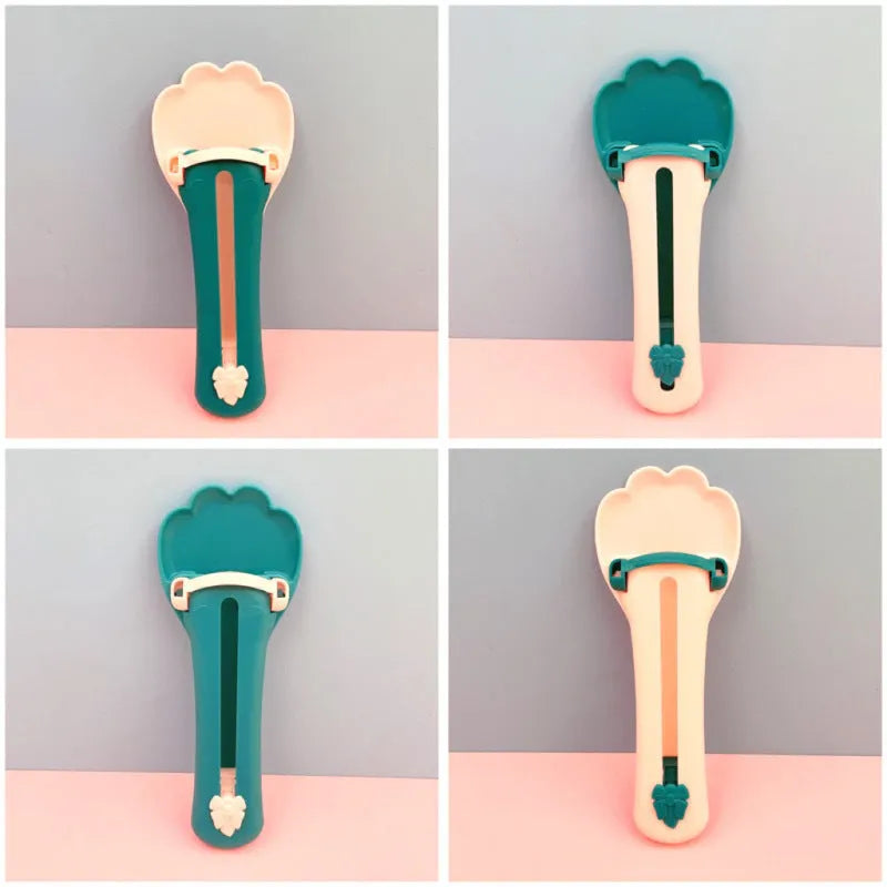 Green and pink two-tone plastic pet food extrusion spoon, 15cm long.