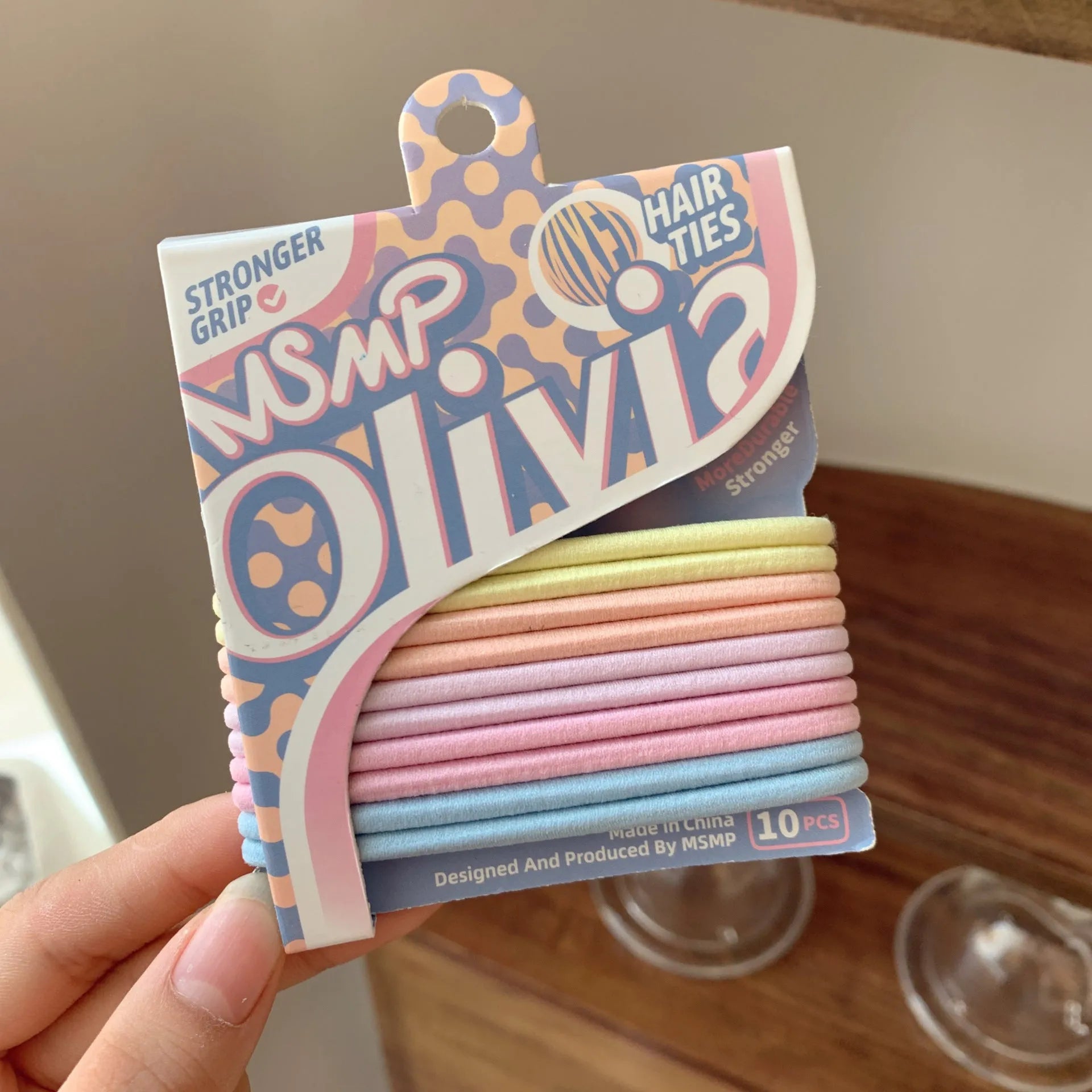 Set of braided elastic hair bands in assorted candy colours on a white background.
