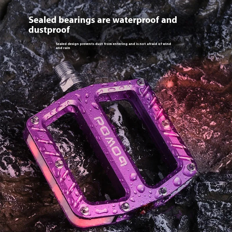 Pair of aluminium alloy bicycle pedals with integrated LED lights in a choice of colours.