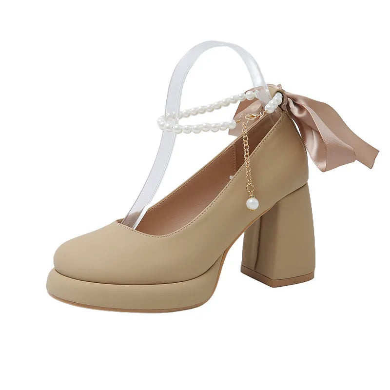 Women's beige Mary Jane shoes with a chunky heel and silver ankle-strap buckle on a round toe PU upper.