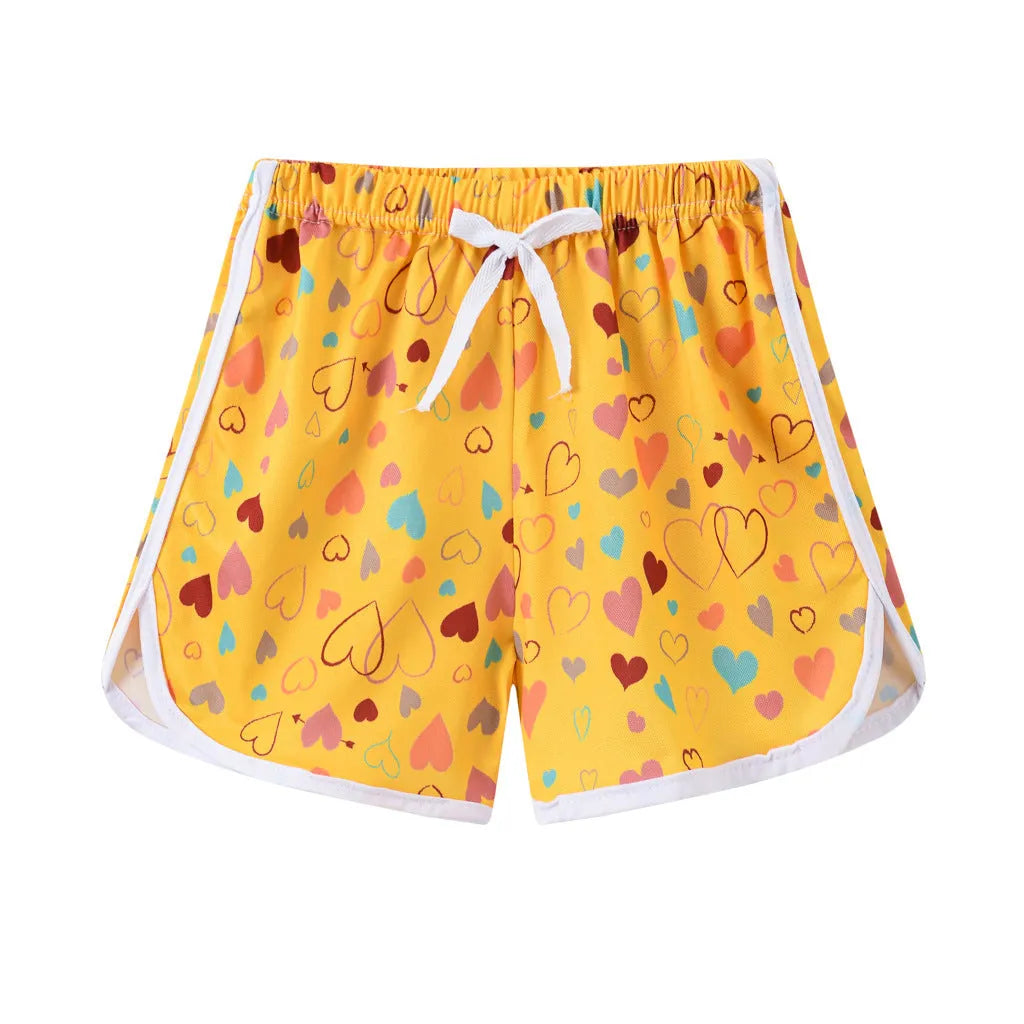 Children's polyester beach shorts in various colors and patterns including pineapple and kitten designs for sizes 100 to 140