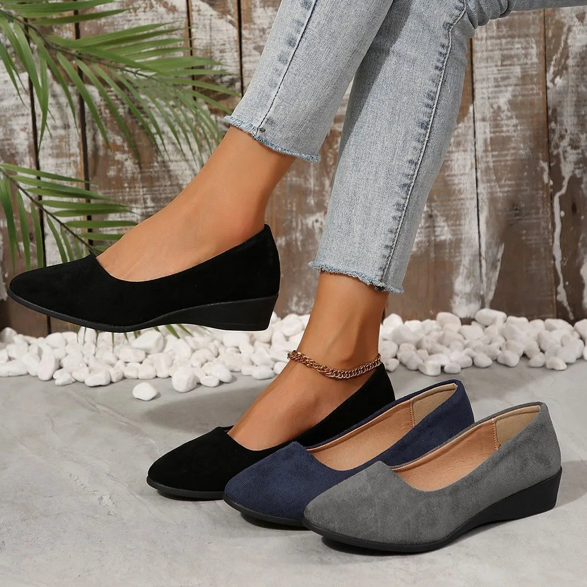 Women's black suede wedge pumps with a low block heel and pointed toe on a rubber sole.