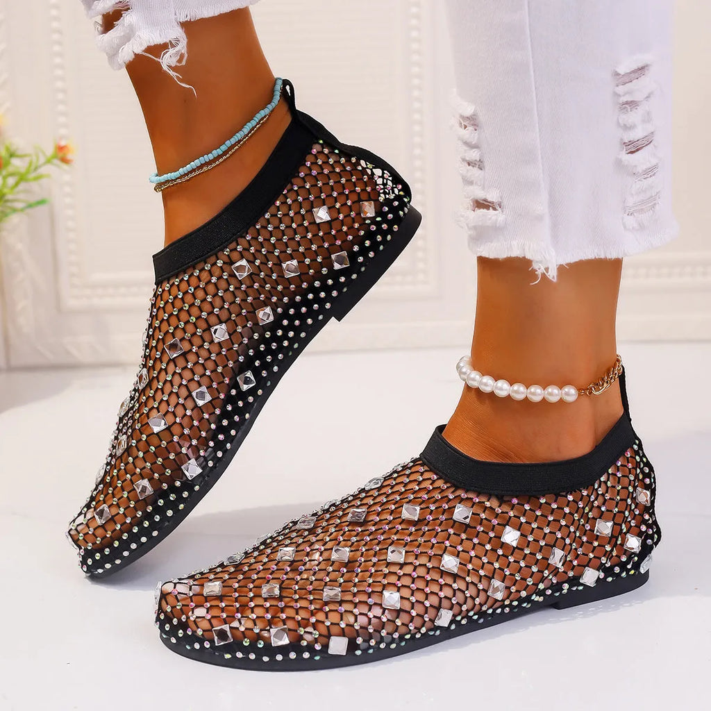 Women's white mesh flat sandals with colourful rhinestone decoration and a rubber sole.