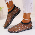 Women's white mesh flat sandals with colourful rhinestone decoration and a rubber sole.