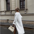 White polyester knit cardigan jacket with extended length and loose fit