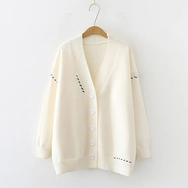 Women's long sleeve loose fit knitted cardigan coat in solid black or white colour.