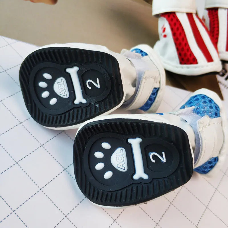 Set of four blue cloth dog shoes with zipper closures and non-slip soles for small pets.
