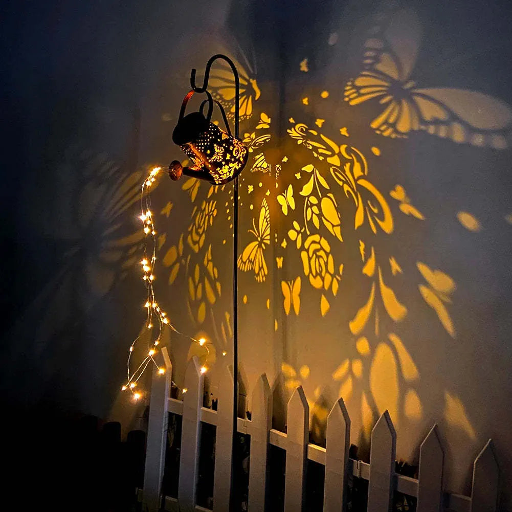 Solar-powered iron butterfly garden lamp with tapered silhouette and warm white LED light