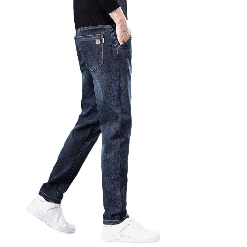 Man wearing blue grey slim straight casual trousers with a loose fit for summer street fashion.