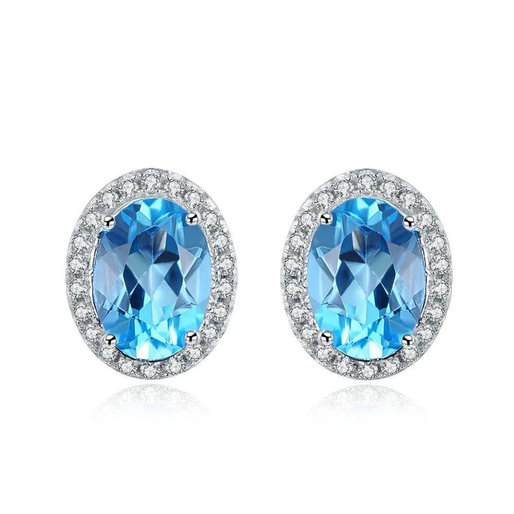 925 sterling silver jewellery set with blue topaz gemstones showing geometric design earrings, ring, pendant, and necklace
