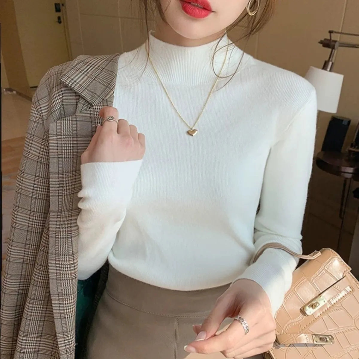 Women's slim fit long sleeve knitted pullover top in viscose fibre, shown in apricot colour.