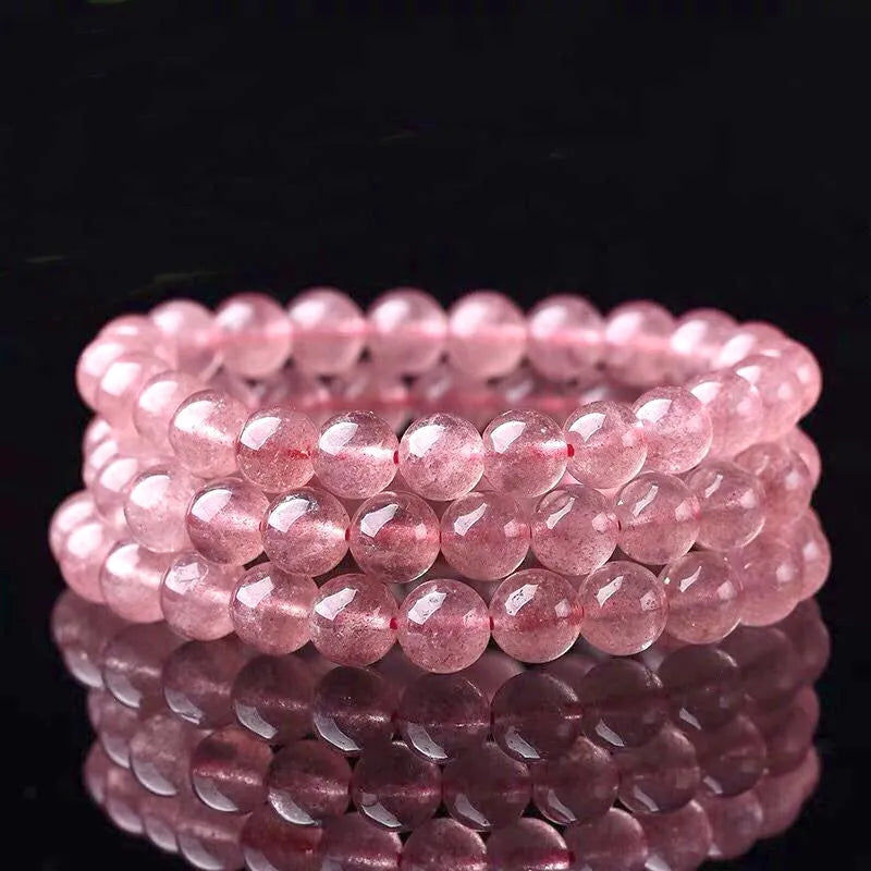 Women's strawberry quartz crystal bracelet showing 10mm, 8mm and 6mm polished beads