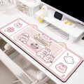 Oversized injection moulded natural rubber desk pad in Pink Bunny, Purple Bear, or Purple Kitten design on a desk.