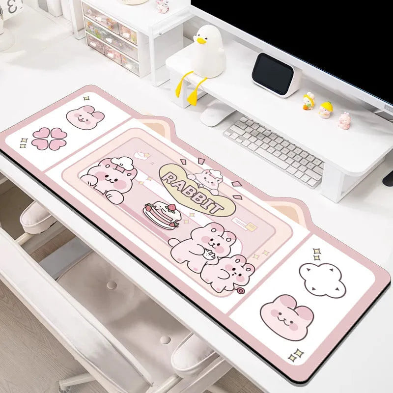 Oversized injection moulded natural rubber desk pad in Pink Bunny, Purple Bear, or Purple Kitten design on a desk.