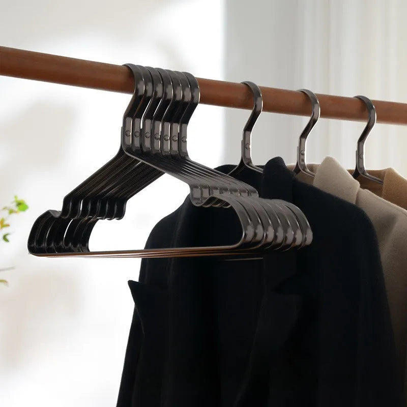 A single elegant black non-slip clothes hanger on a white background.