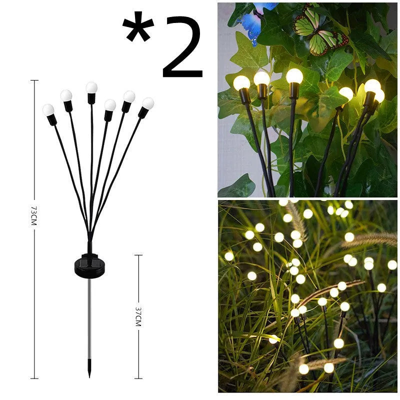 Solar-powered LED firefly garden spike light with stainless steel ground stake illuminated at dusk.