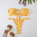 Women's floral print tube top bikini set with briefs on a neutral background.