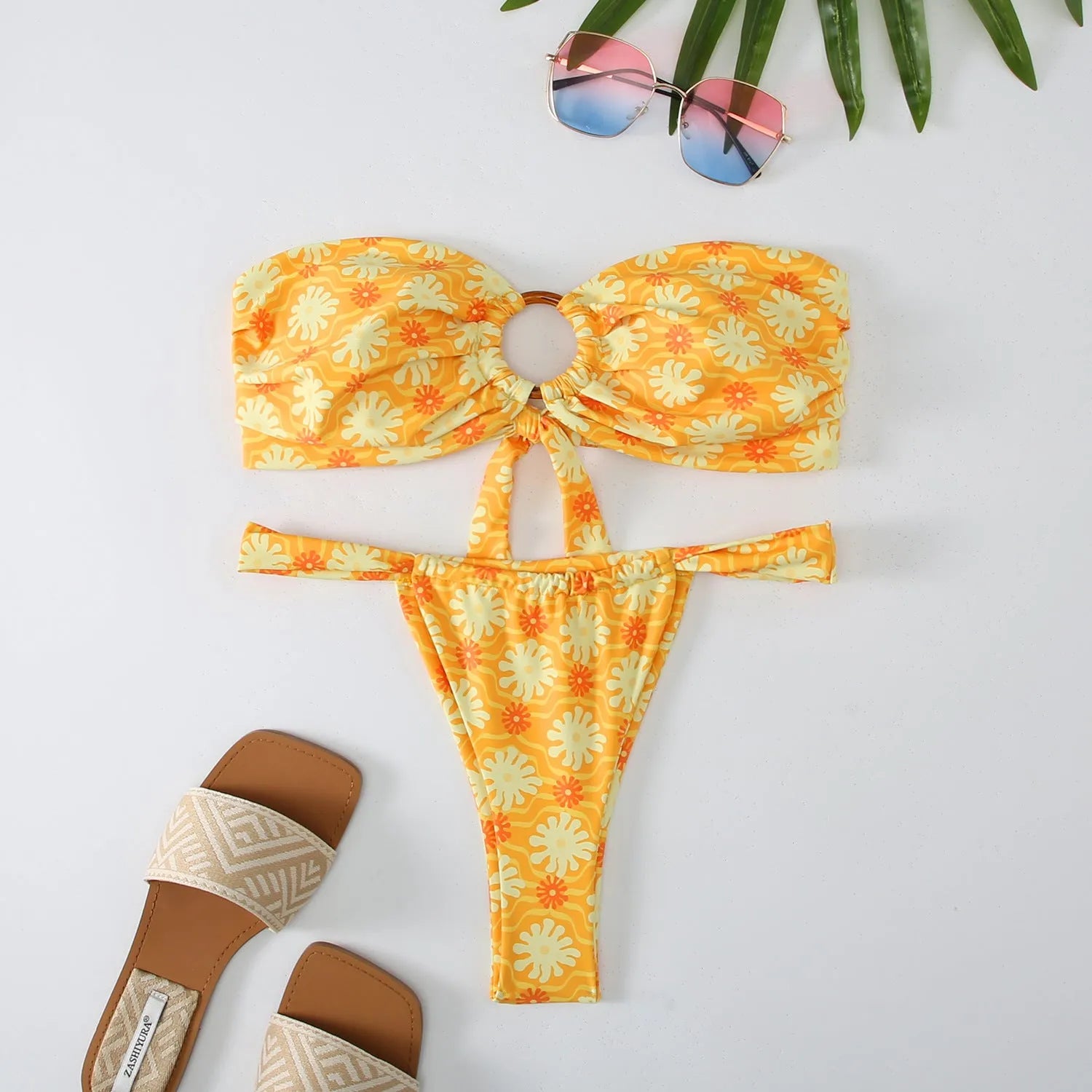 Women's floral print tube top bikini set with briefs on a neutral background.