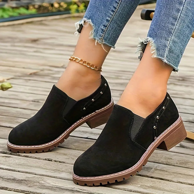 Light brown suede women's ankle boots with low heel and elastic band on a white background.