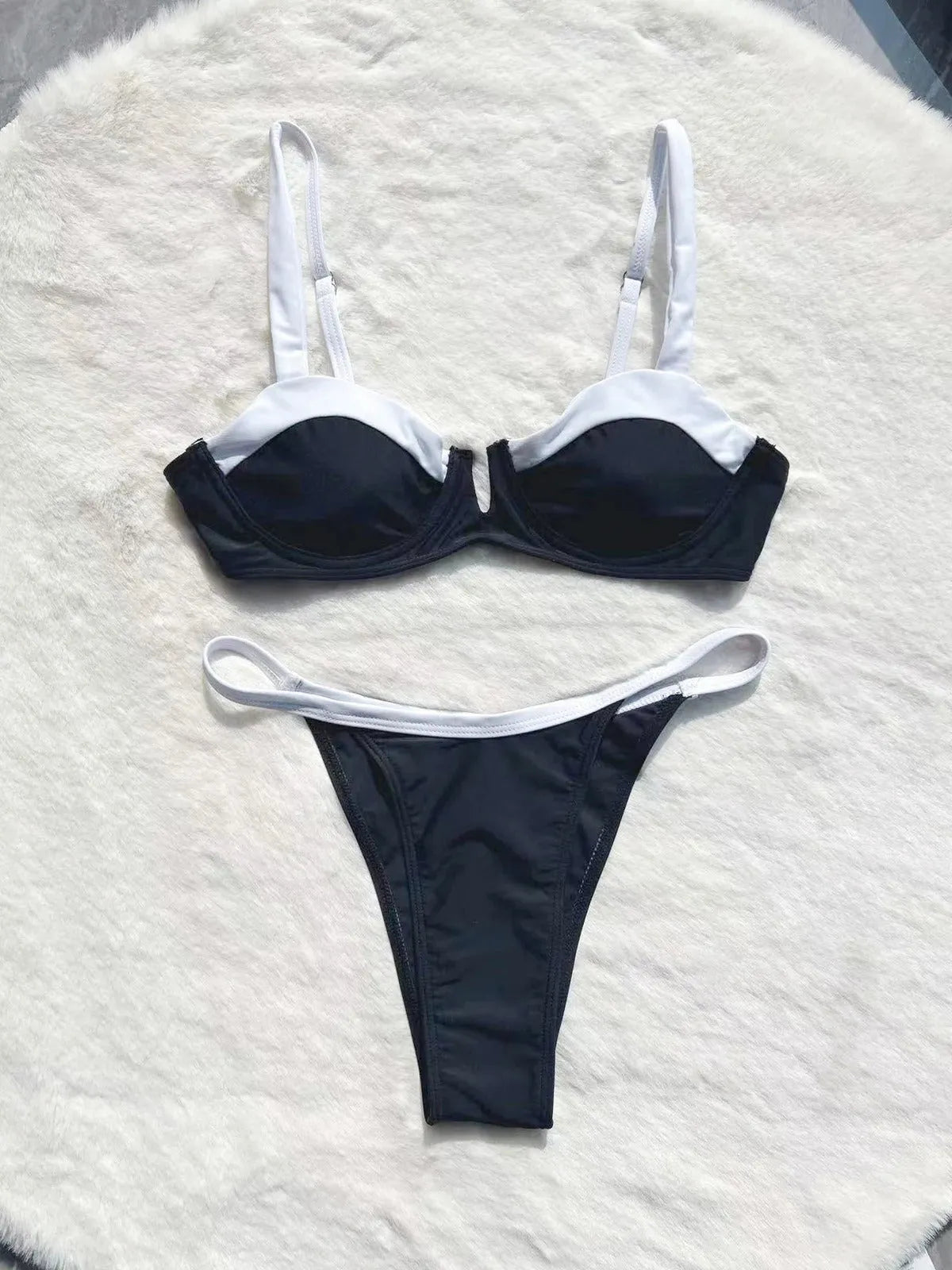 Black low waist women's bikini swimsuit with stitching split detail and briefs style.