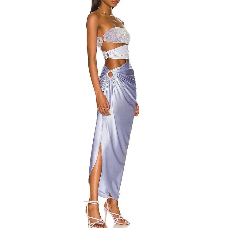 Purple one-piece swimsuit with hollow back and matching wrap skirt laid flat.