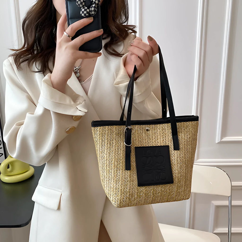 Straw woven women's shoulder bag with 27cm width showing three-dimensional pocket and 18cm handle