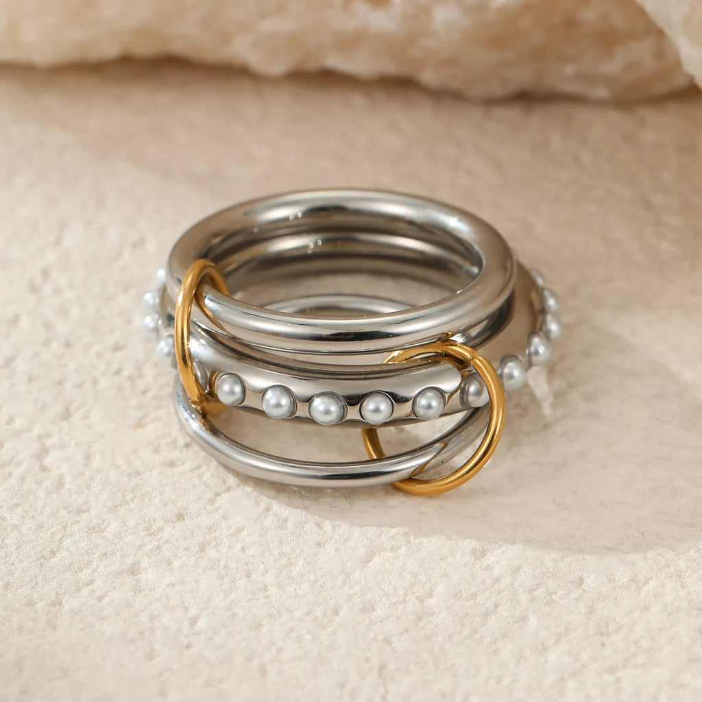 Stacked colour matching stainless steel rings with 18K gold plating in three colour variants for women