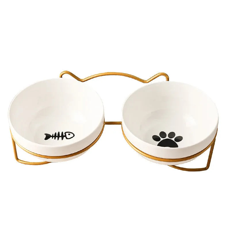White ceramic cat food bowl with cat paw print design on black iron frame stand