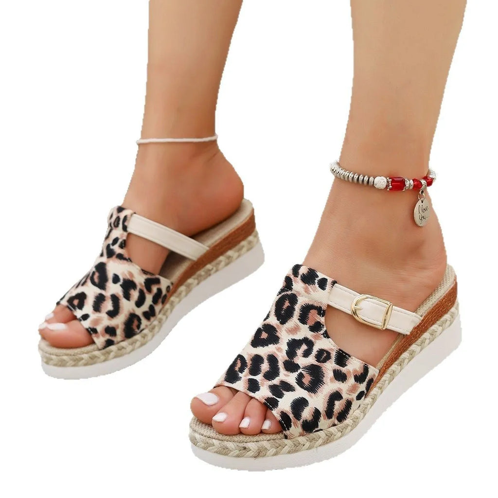 Leopard print women's wedge sandals with a fish mouth open toe on a rubber sole.