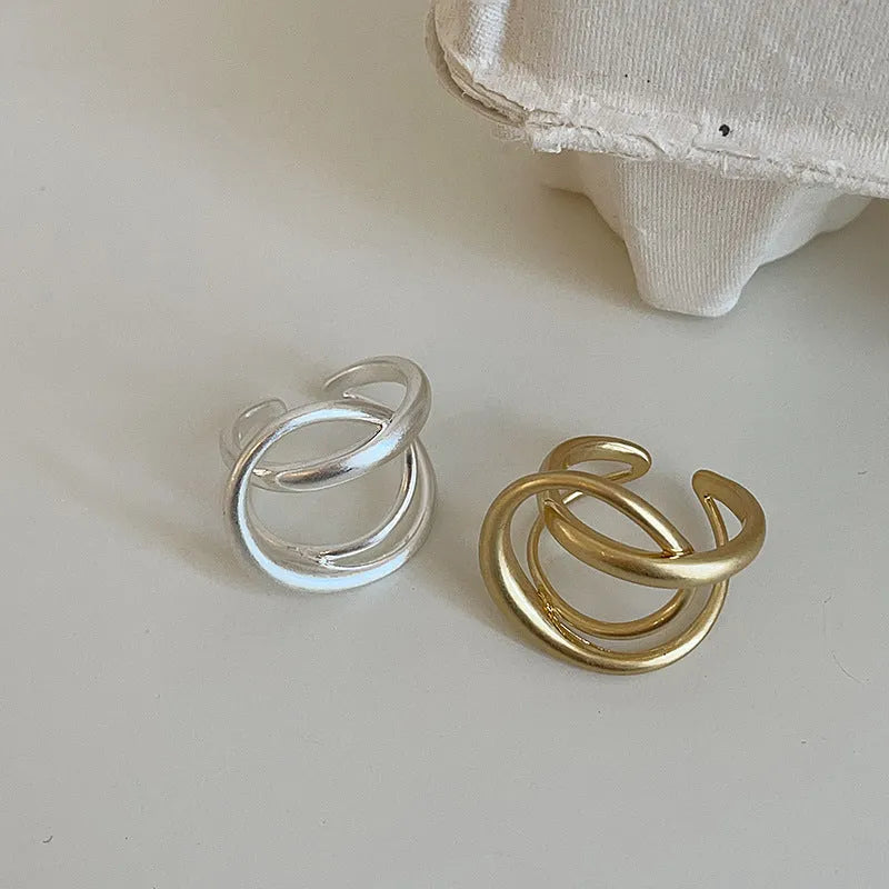 Geometric open ring with interlaced matte metal pattern in gold or silver electroplated finish