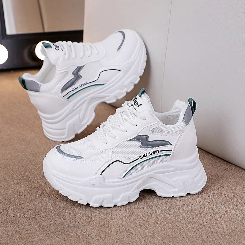 Women's white and beige dad shoes with lace-up front and rubber sole showing mesh material detail