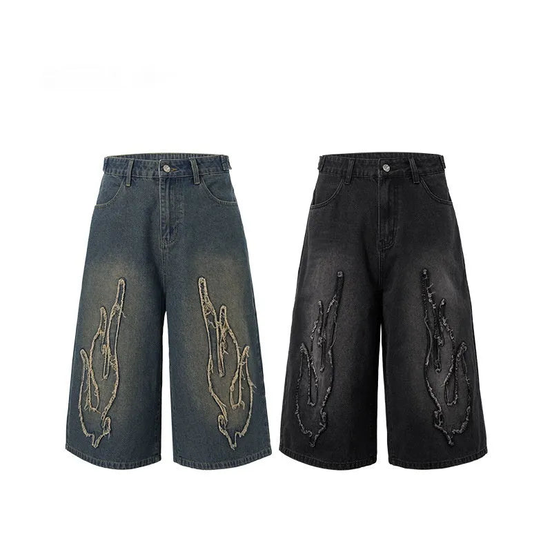 Men's black denim shorts with red flame embroidery patches on legs