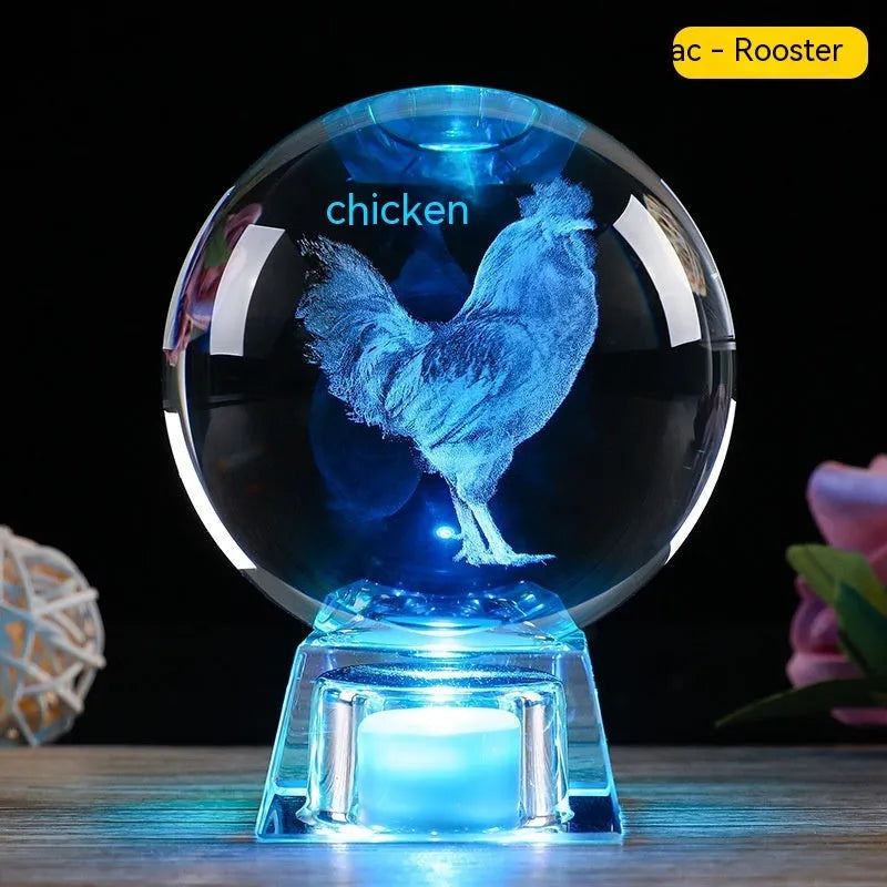 White luminous crystal ball ornament with Chinese zodiac animal figure on electronic base.