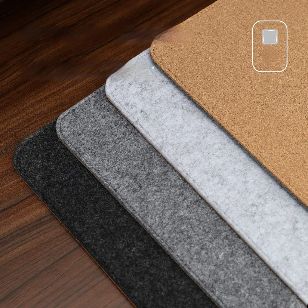 Oversized felt cork desk mouse mat in black and grey pattern, shown on a wooden desk.