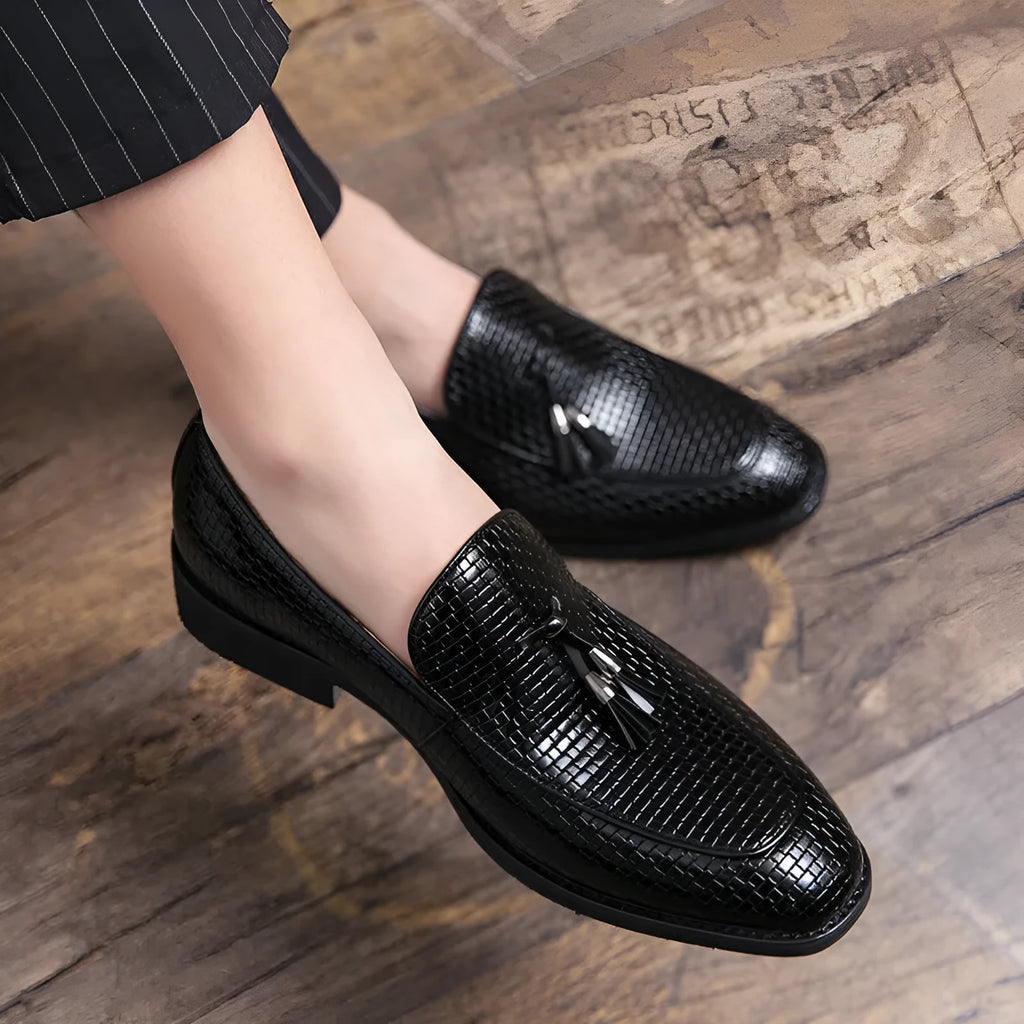 Men's black pointed slip-on shoe with a tassel on a business-style artificial PU upper.