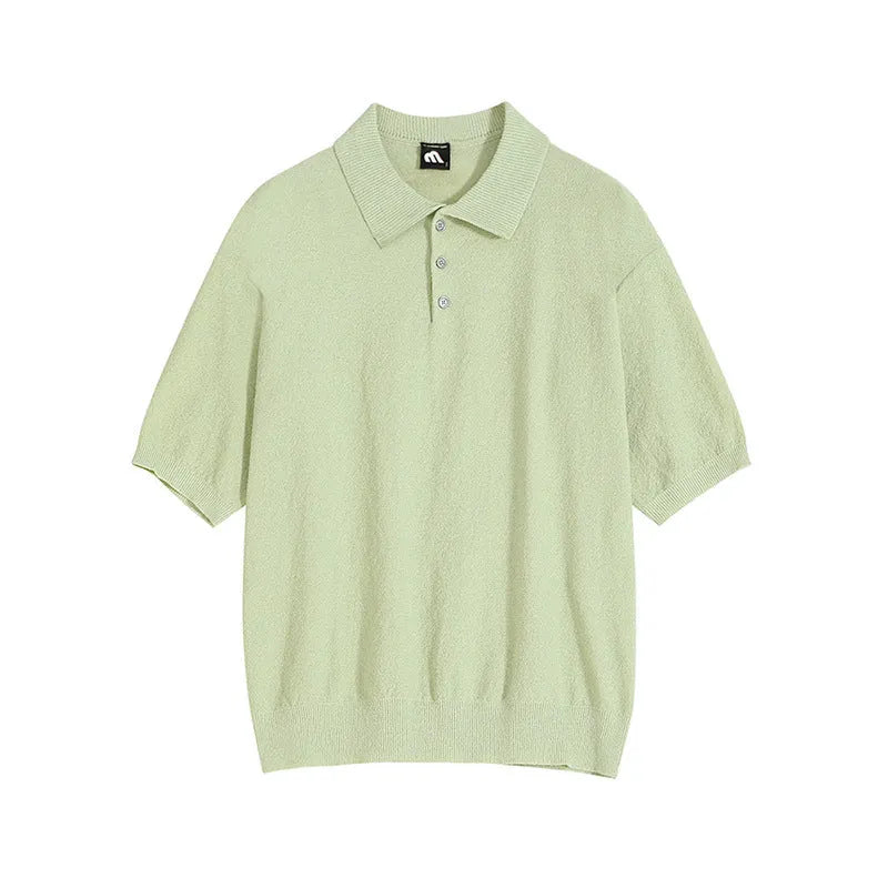 Man wearing a caramel-coloured loose-fit knitted polo shirt with short sleeves and an asymmetrical design detail.