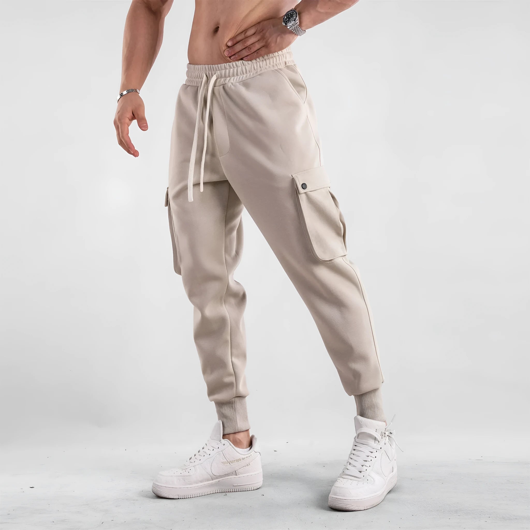 Men's loose fit multi-pocket cotton trousers with ankle ties in apricot colour