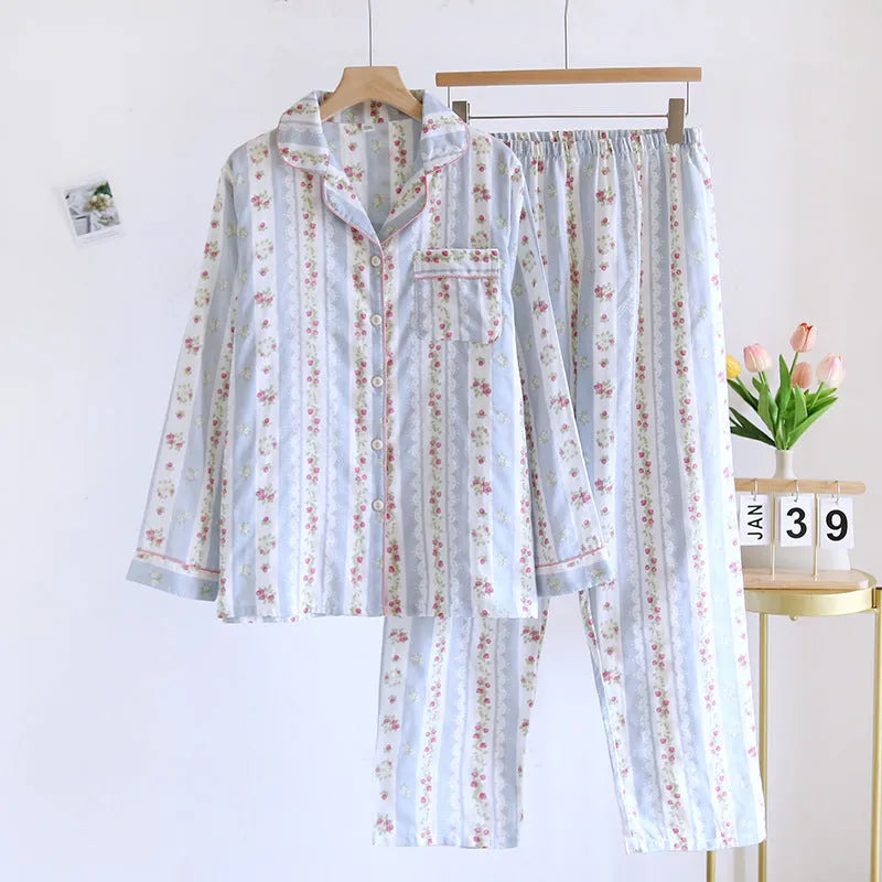 Red and white small fruit patterned cotton gauze long-sleeved top and trousers homewear set laid flat.