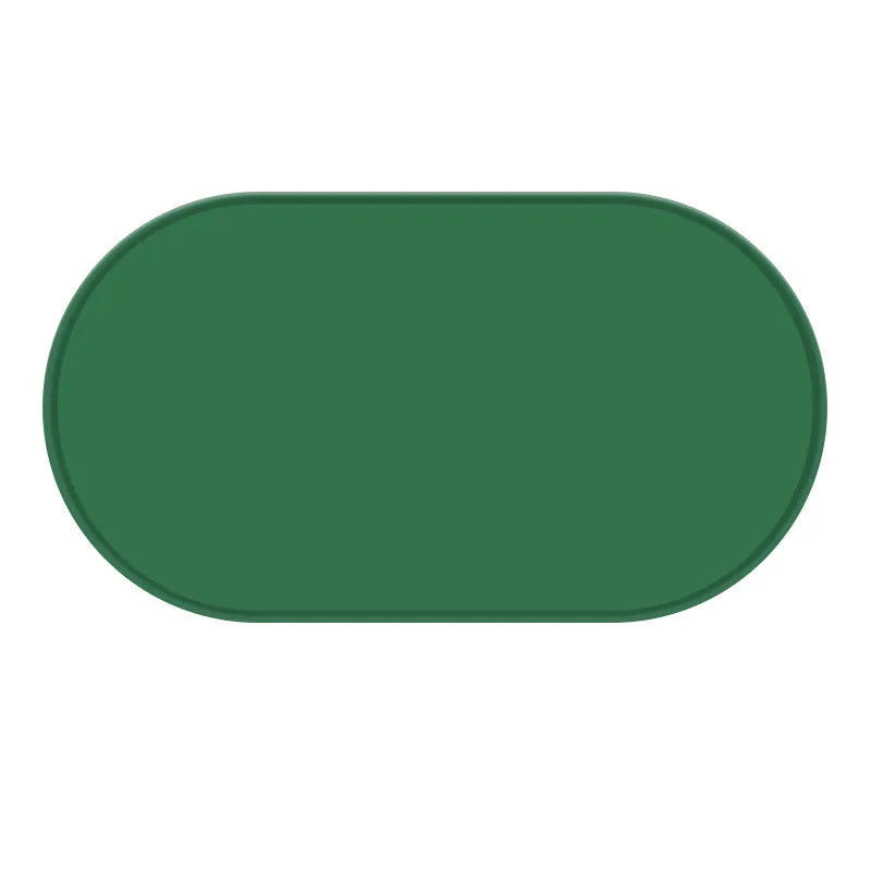 Green silicone waterproof placemat for cat bowls on a wooden floor