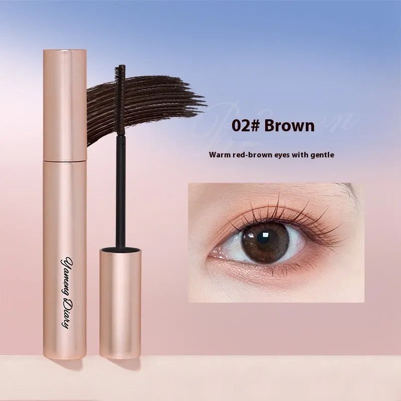 Black mascara tube with brush applicator for curling and volumising lashes