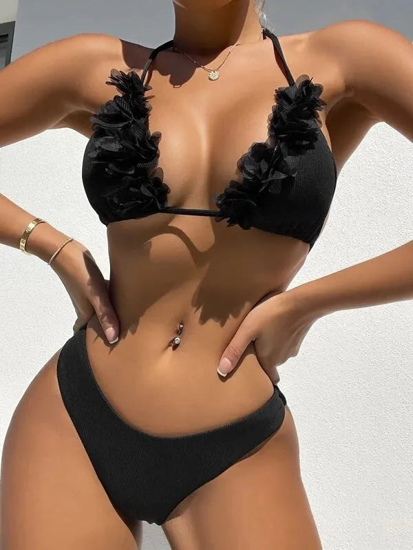 Black gathered style women's bikini top and shorts swimwear set on a mannequin