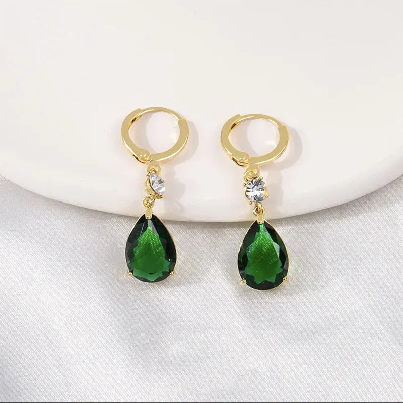 A pair of emerald green geometric teardrop earrings made from alloy.