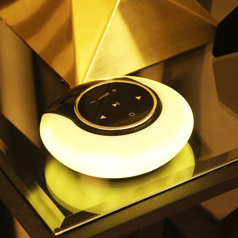 Blue foldable Bluetooth desk lamp speaker with touch controls for dimmable LED lighting.