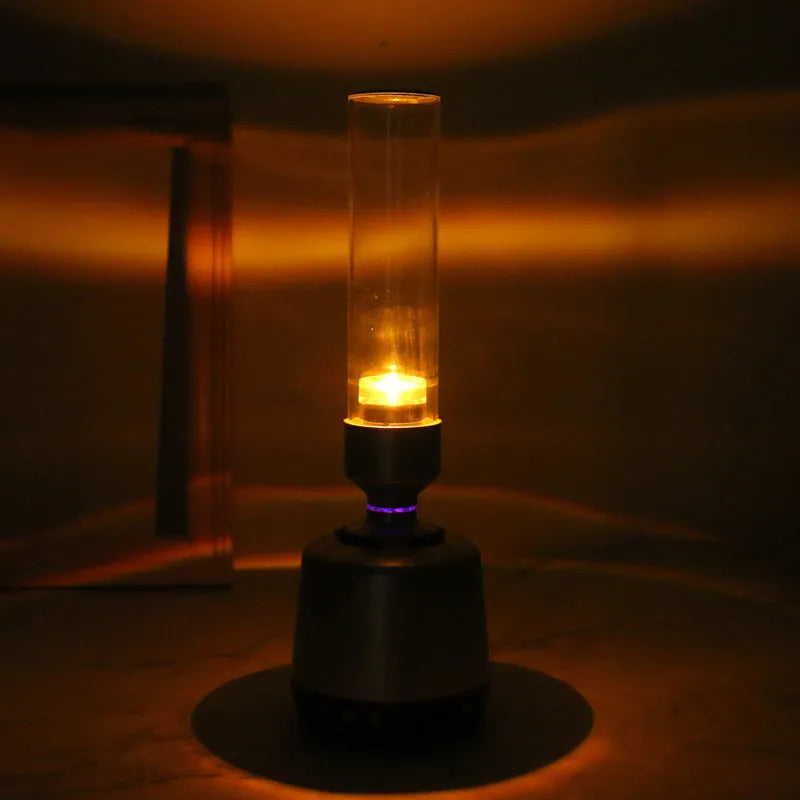 White silver Bluetooth speaker with candlelight night light feature measuring 90x277mm