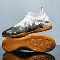 Low-top soccer boots in black and yellow colourway with spiked rubber sole, shown on a firm ground surface.